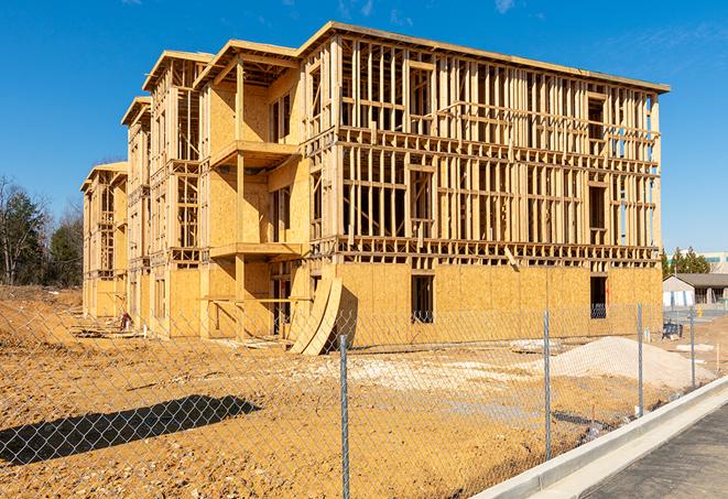 a close-up of temporary chain link fences enclosing a job site, signaling progress in the project's development in Concord